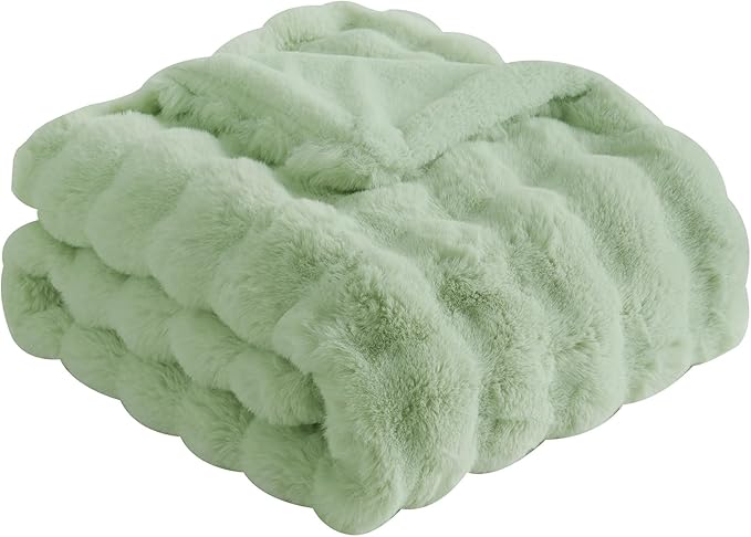 Stack of light green textured fabric on a white background