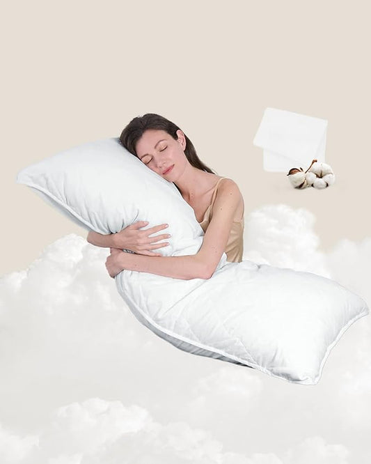 Woman sleeping peacefully with a white pillow on a bed.