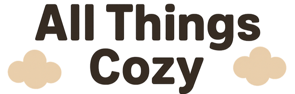 Logo for 'All Things Cozy' with text and cloud shapes on a white background